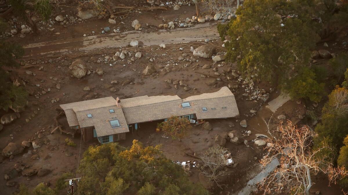 A home in the Romero Canyon area is surrounded by mud and debris in Montecito.