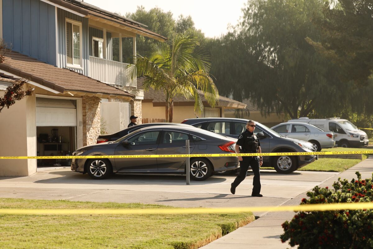 Placentia street is blocked by police tape during investigation of triple homicide