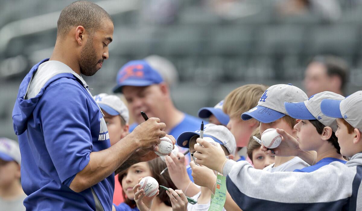 Dodgers center fielder Matt Kemp signs autographs for fans before a game against the Mets in New York.