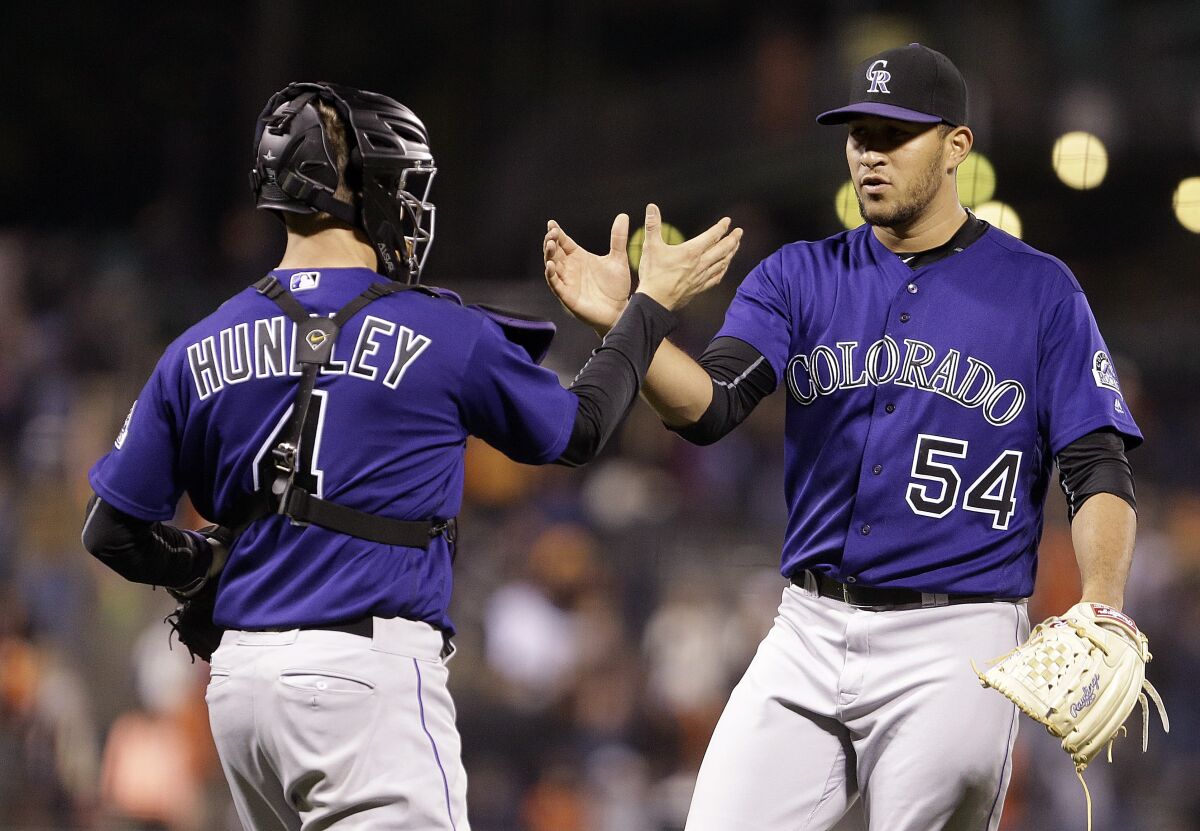 The Rockies' Carlos Estevez, right, and Nick Hundley celebrate a win in 2016, the year Estevez made his MLB debut.