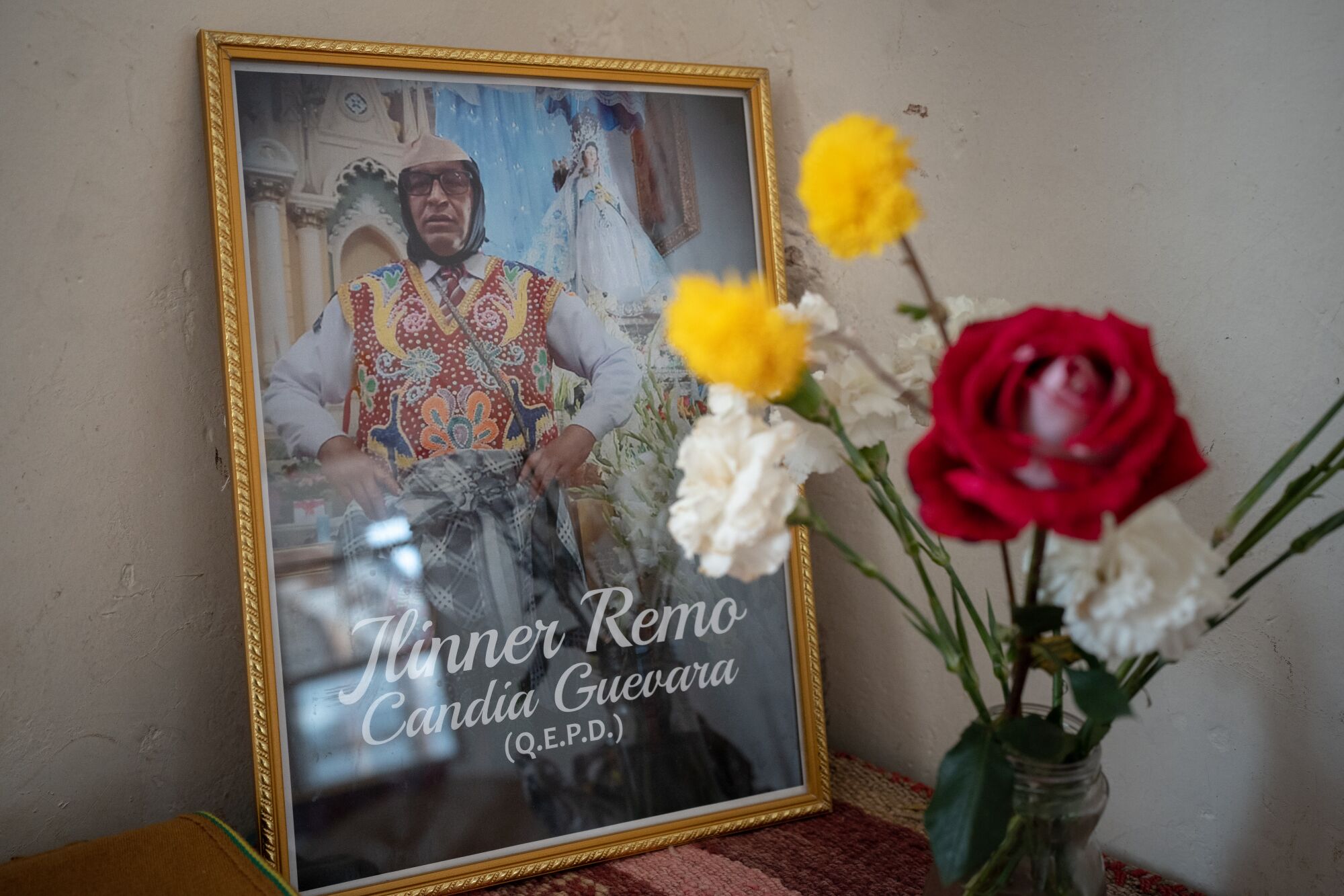 Rage and hope in Peru as protests spill from Andes into Lima 2 A photograph of Remo Candia Guevara sits beside a vase of flowers.