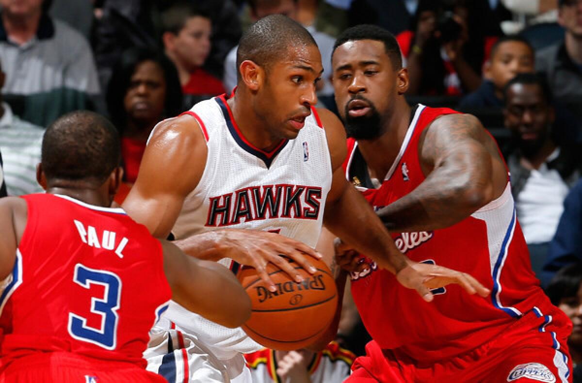 Clippers center DeAndre Jordan, right, tries to cut off a drive by Atlanta center Al Horford during a game on Wednesday.