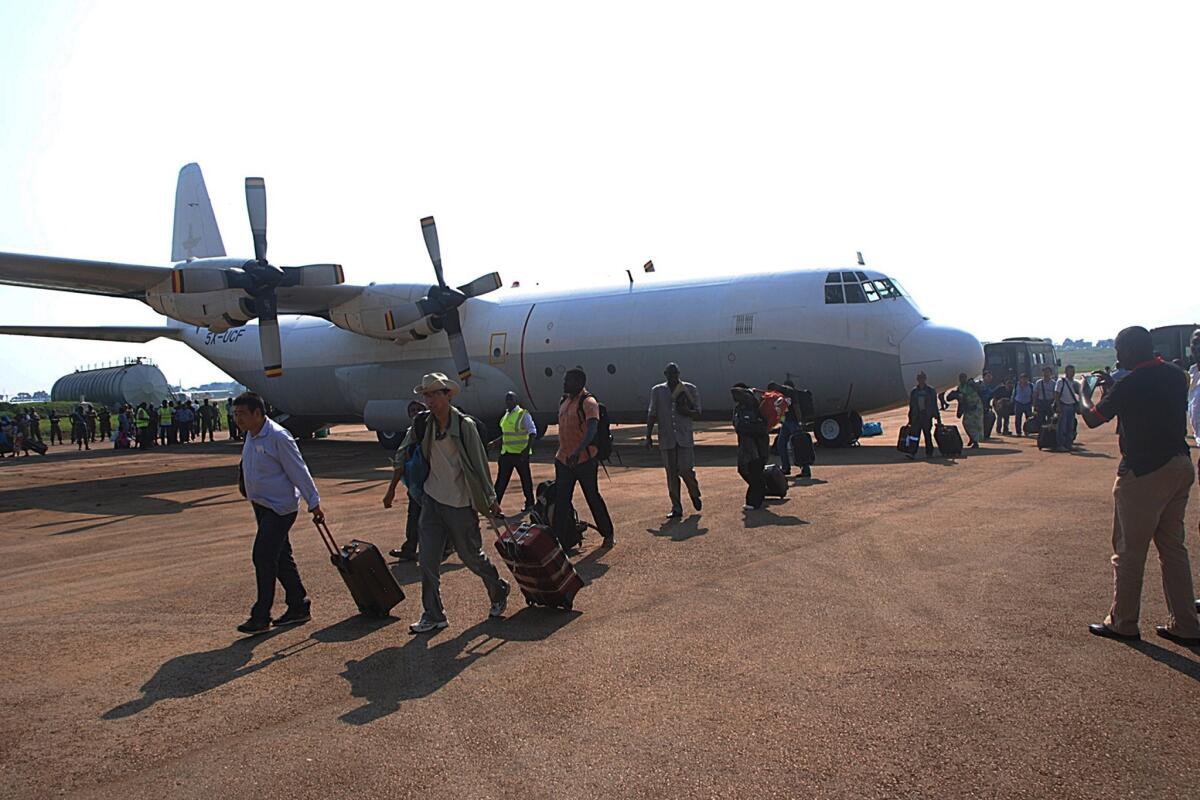 Civilians who were evacuated from South Sudan arrive at the Entebbe International Airport in Uganda.