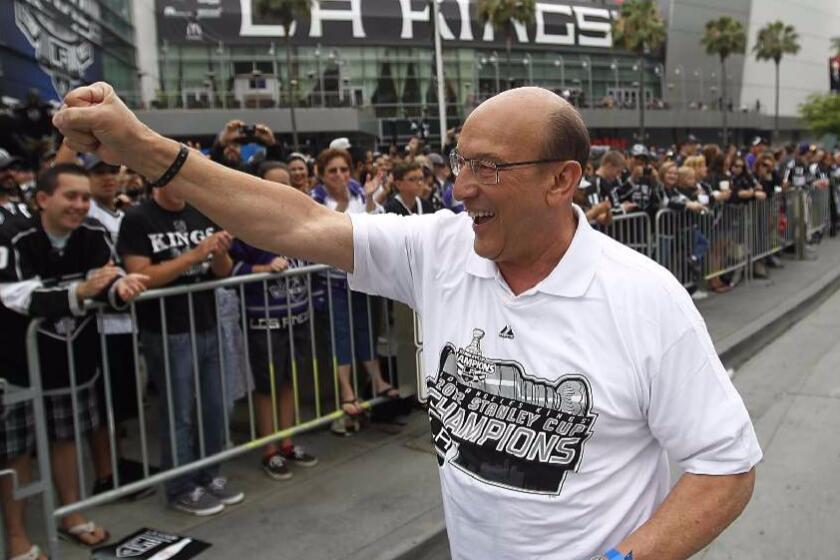 Kings broadcaster Bob Miller is cheered by fans outside of Staples Center during the Kings' Stanley Cup parade on June 14, 2012.