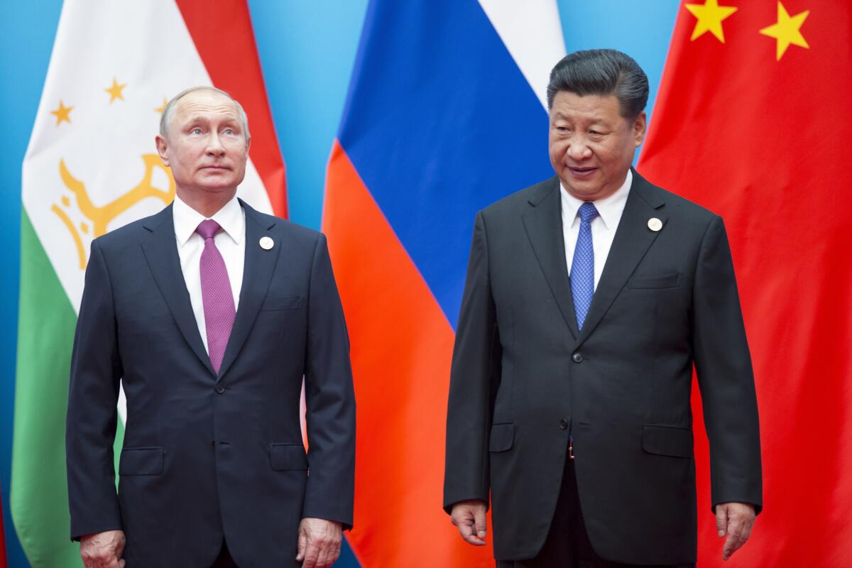 FILE - Chinese President Xi Jinping, right, and Russian President Vladimir Putin pose for a photo at the Shanghai Cooperation Organization (SCO) Summit in Qingdao in eastern China's Shandong Province on June 10, 2018. President Xi Jinping is using his first trip abroad since the start of the pandemic to promote China's strategic ambitions at a summit with Putin and other leaders of a Central Asian security group. (AP Photo/Alexander Zemlianichenko, File)