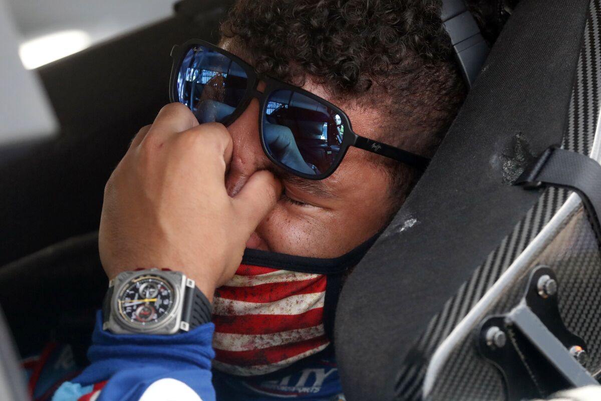 Driver Bubba Wallace is overcome with emotion for the support from fellow drivers at the Talladega Superspeedway on Monday.