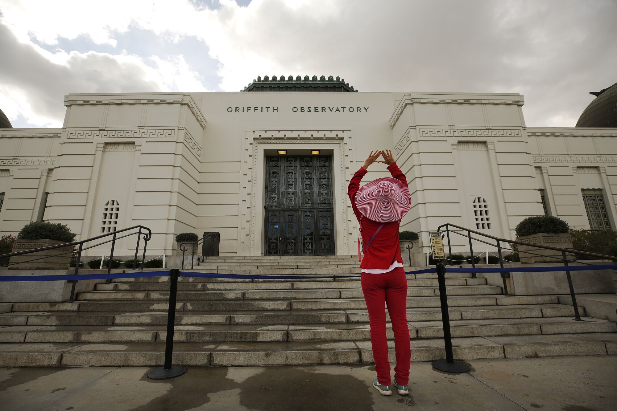 Justine Kleinman raises her arms during her walk at Griffith Observatory