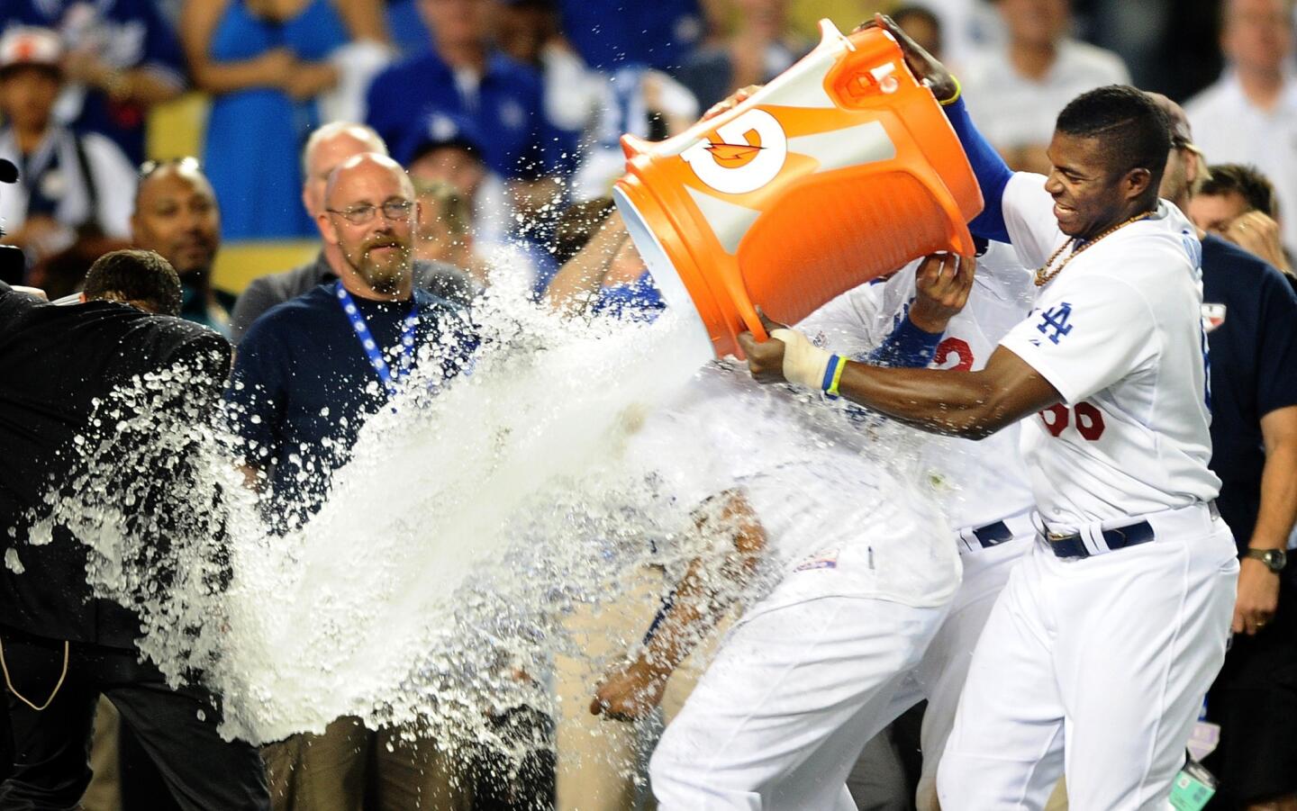 Dodgers right fielder Matt Kemp is doused with water by center fielder Yasiel Puig after the team's 3-2 victory over the Cardinals in Game 2 of the National League division series on Saturday night at Dodger Stadium.