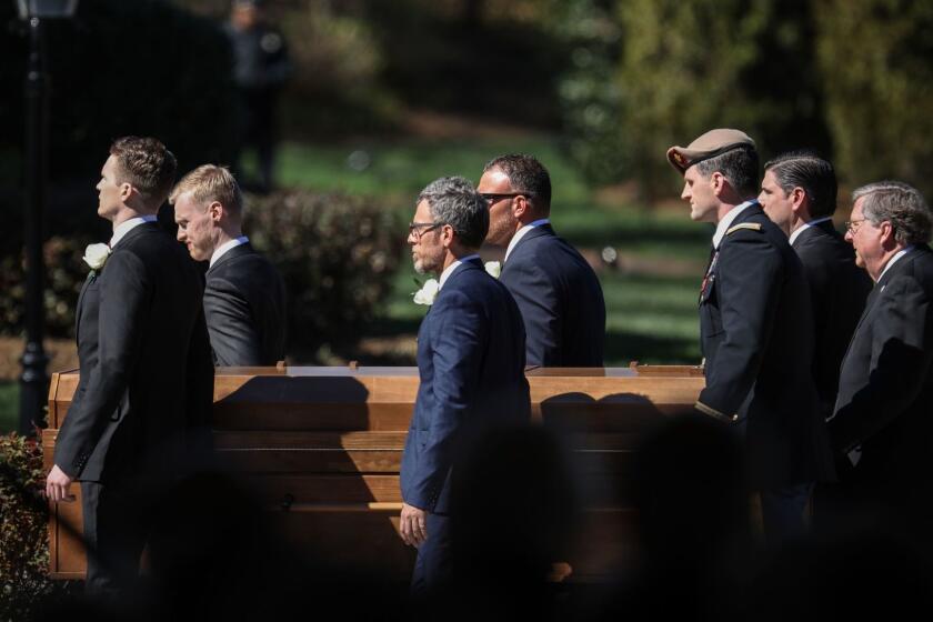 Pallbearers carry the body during the funeral of Reverend Billy Graham at his funeral in Charlotte, North Carolina. Graham, who preached to millions of faithful face to face over his decades-long career and tens of millions more through the power of television, died last week at age 99, leaving a Christian evangelist movement without its best known champion of modern times. / AFP PHOTO / Logan CyrusLOGAN CYRUS/AFP/Getty Images ** OUTS - ELSENT, FPG, CM - OUTS * NM, PH, VA if sourced by CT, LA or MoD **
