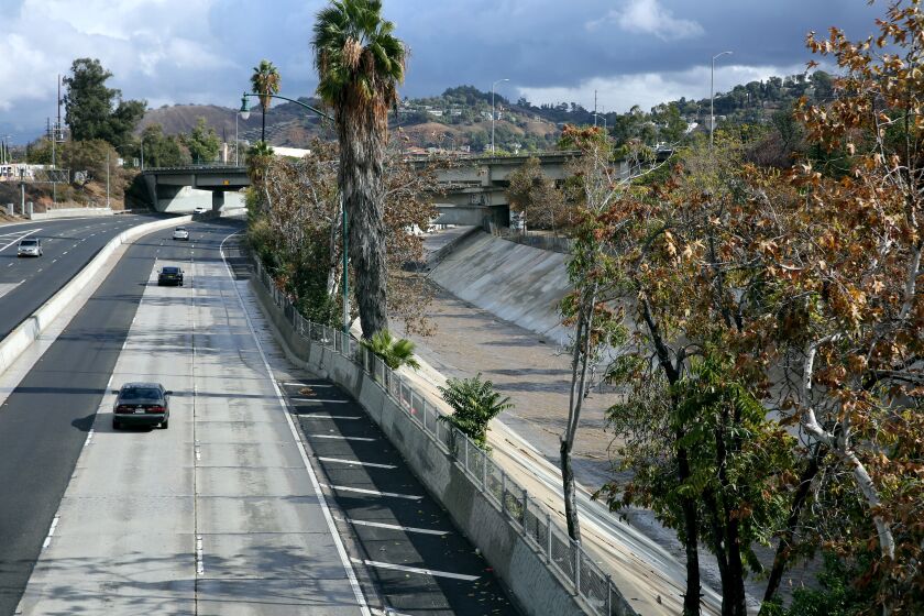 Parallel to the 110 Arroyo Seco Parkway, the Arroyo Seco carries storm run-off as it flows south near the 26th St. bridge in Los Angeles on Tuesday, Nov. 8, 2022. Two vehicles were reported in the water earlier in the day.