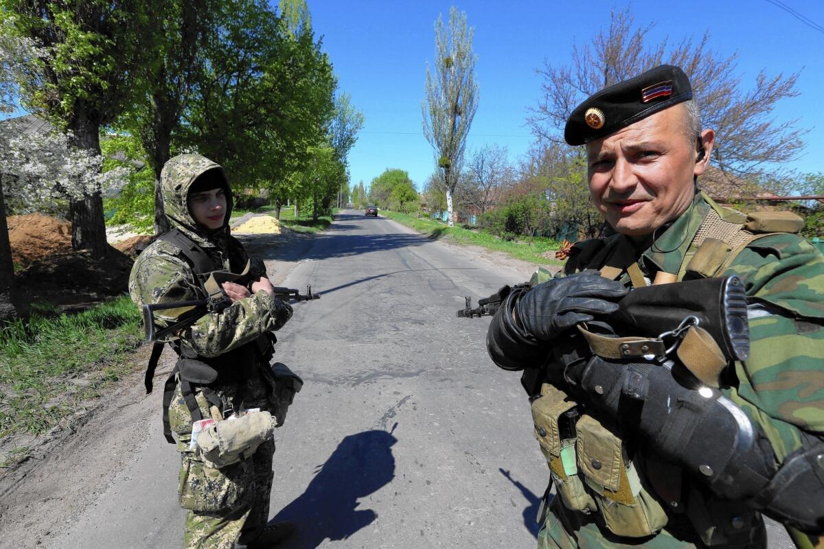 A Russian gunman who goes by the codename Popeye, right, patrols the streets of Slovyansk, Ukraine.