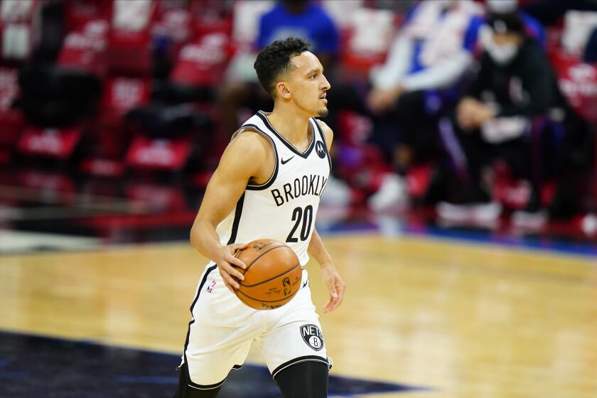 Nets guard Landry Shamet brings the ball up court during a game against the 76ers on Feb. 6, 2021.
