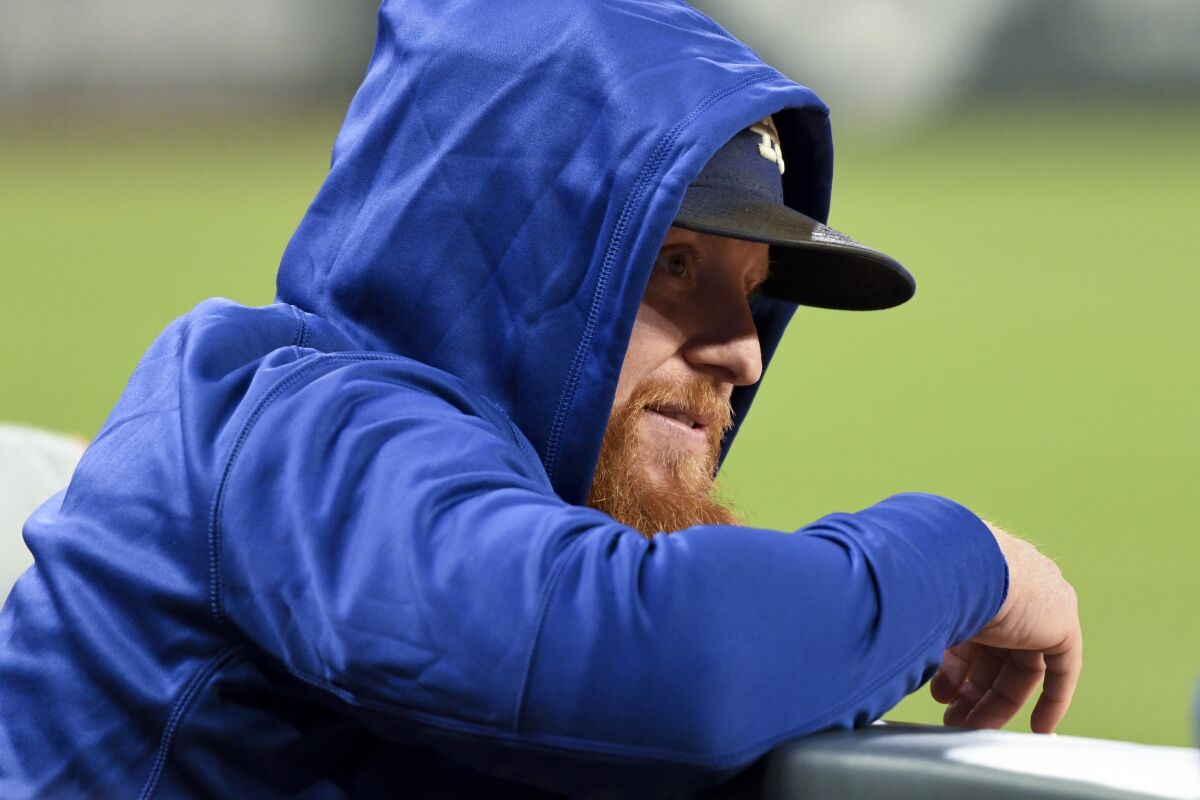 Dodgers third baseman Justin Turner watches from the dugout during Game 2 of the NLCS on Sunday.