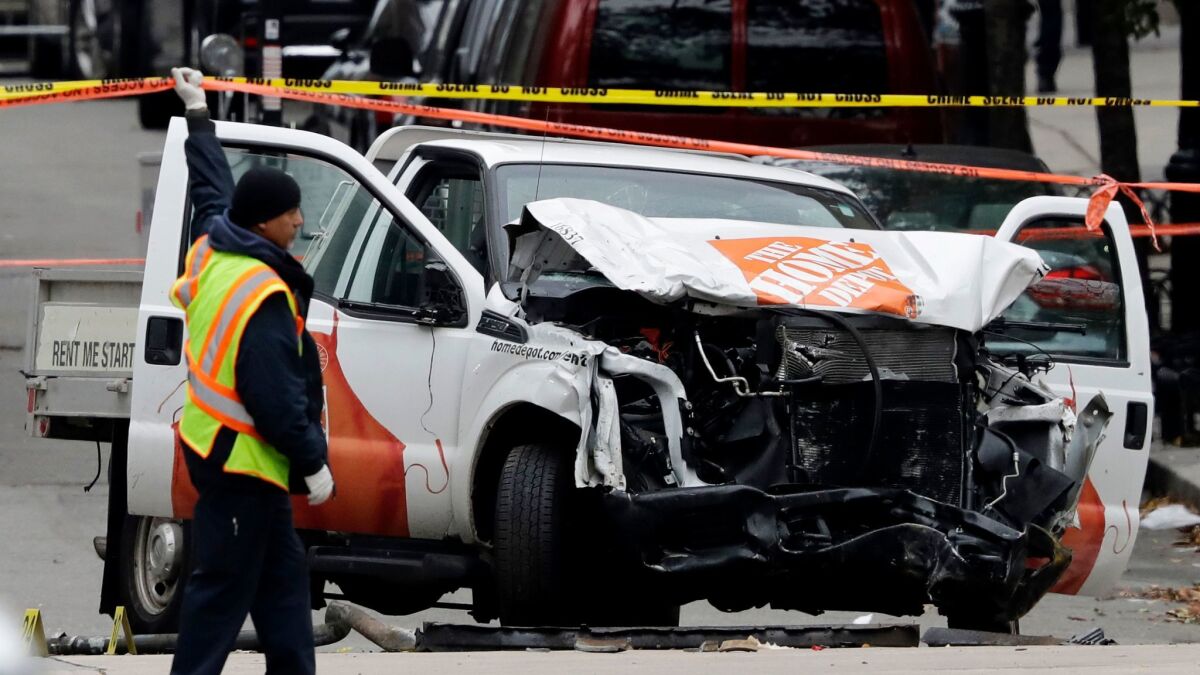 A damaged Home Depot truck remains on the scene after the driver mowed down people on a riverfront bike path near the World Trade Center on Tuesday in New York.