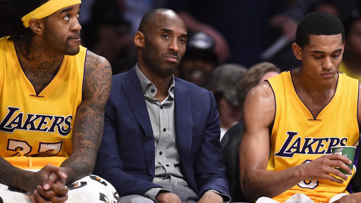 Lakers star Kobe Bryant sits between teammates Jordan Hill, left, and Jordan Clarkson during a game against the Detroit Pistons back in March.