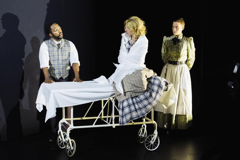 This image released by Opera Philadelphia shows Baritone Will Liverman as Dr. Josiah Blackwell, left, soprano Kiera Duffy as Nellie, center, and soprano Lauren Pearl as Nurse/Matron during a rehearsal of Rene Orth’s “10 Days in a Madhouse” at Opera Philadelphia. (Opera Philadelphia/Dominic M. Mercier)