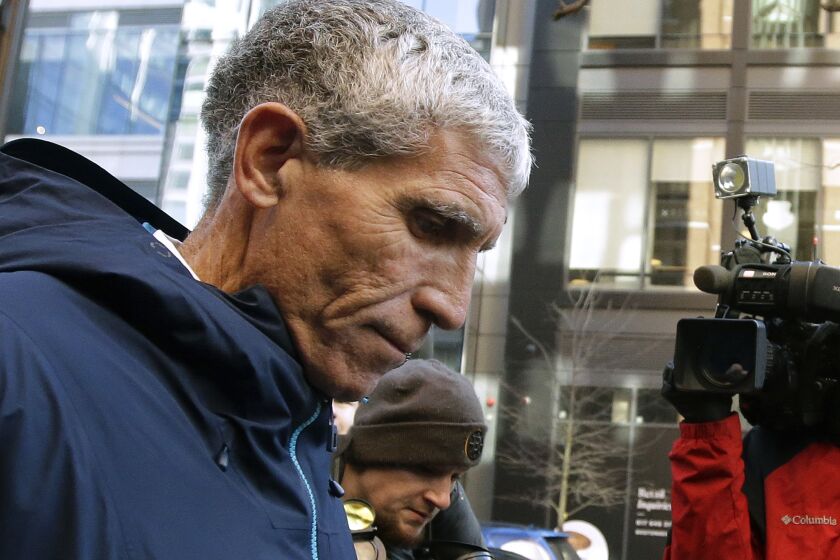 FILE - In this March 12, 2019 file photo, William "Rick" Singer founder of the Edge College & Career Network, departs federal court in Boston after he pleaded guilty to charges in a nationwide college admissions bribery scandal. A total of 50 people have been charged, including 33 parents, 10 coaches and college athletics officials, and seven others. (AP Photo/Steven Senne, File)