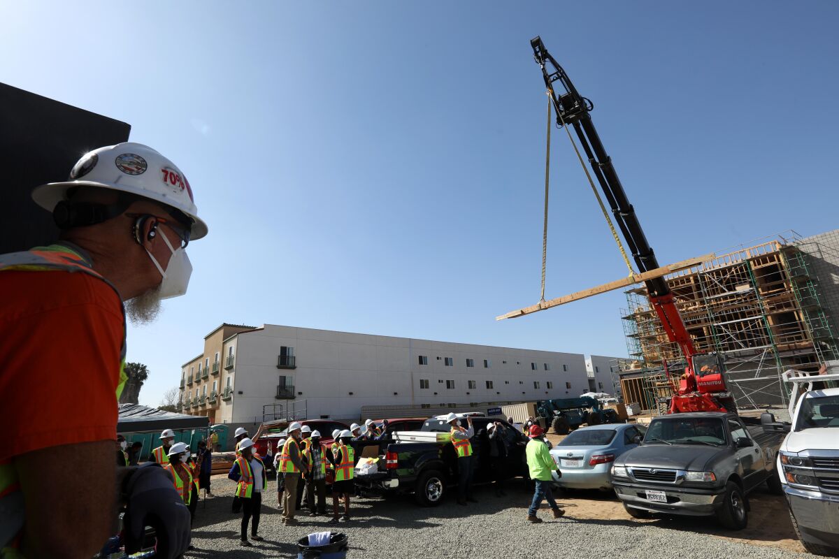 The top beam for the Union Rescue Mission's Angeles House is raised by crane.