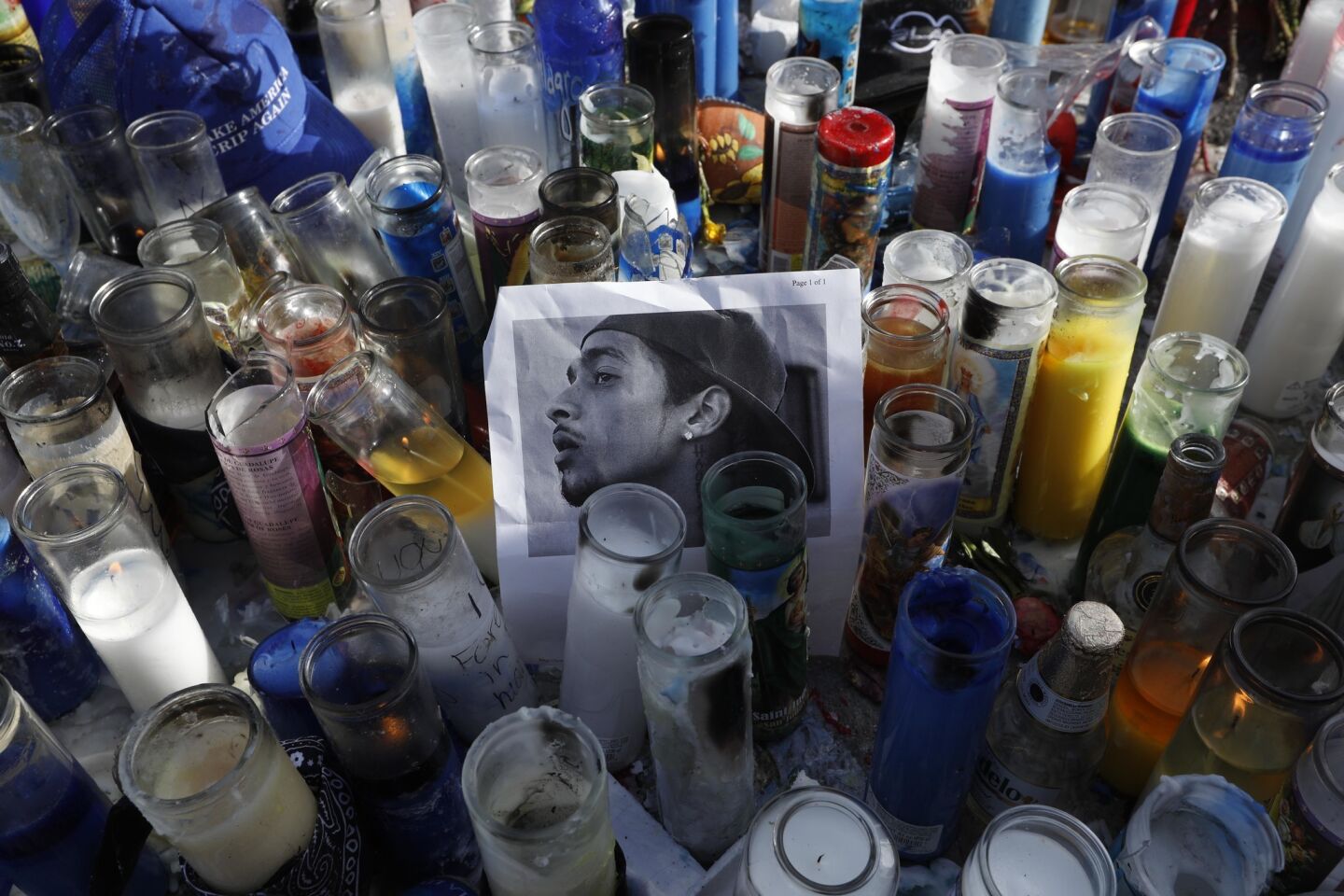 An image of Nipsey Hussle rests in a sea of candles as fans of the rapper pay their respects near the Marathon Clothing store in South Los Angeles on Monday.