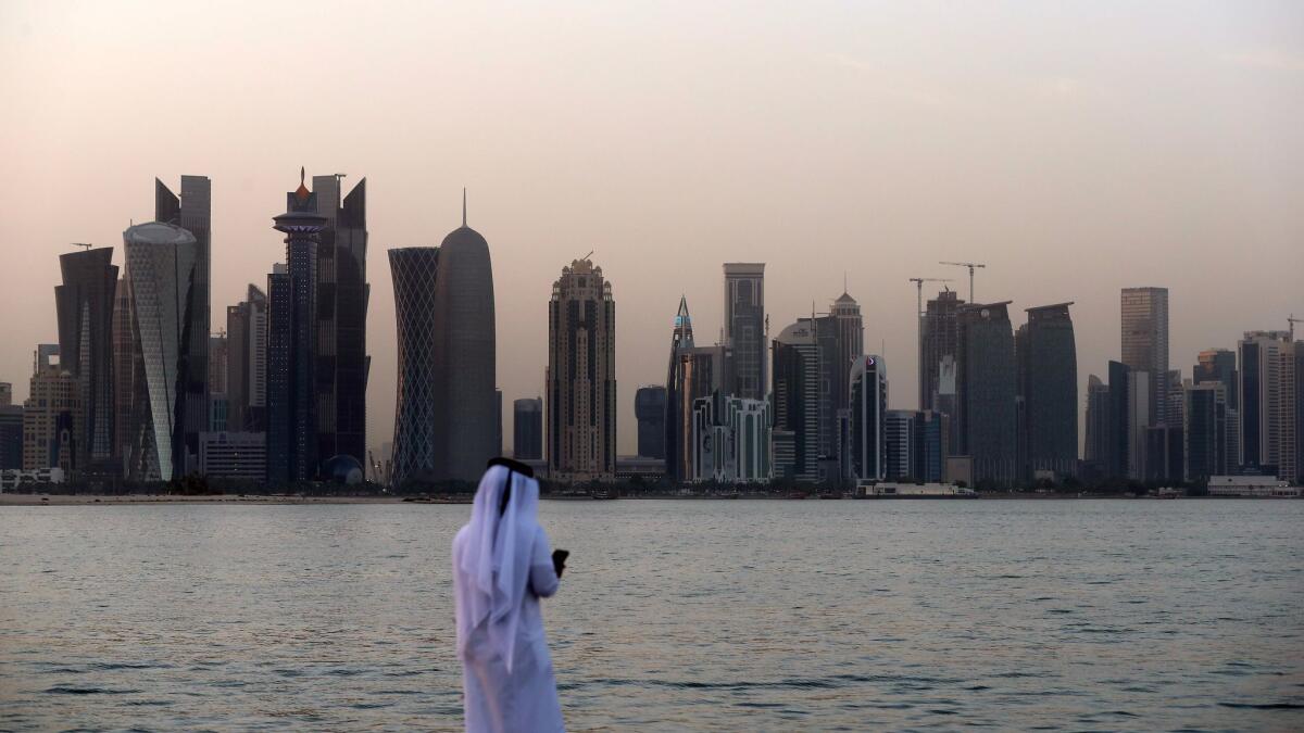 A man checks his phone in Qatar's capital, Doha, on July 2, 2017.