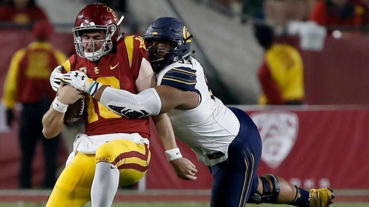 USC quarterback J.T. Daniels is sacked by California defensive end Luc Bequette during a game at the L.A. Memorial Coliseum on Nov. 10, 2018.