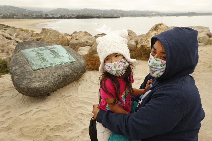 SANTA BARBARA , CA - SEPTEMBER 02: Yadira Alvarez-Peterson holds her 3-year-old daughter Renata Alvarez-Peterson close talking about her 16-year-old daughter Berenice Felipe, who was one of the 34 people who died in the Conception Boat fire one year ago today as family members with friends and officials gathered at Point Castillo at the end of Harbor Walk in the Santa Barbara Harbor where a plaque on a boulder was unveiled to memorialize the 34 lives lost in the Conception Diving Boat fire off Santa Cruz Island on the one year anniversary. Santa Barbara Harbor on Wednesday, Sept. 2, 2020 in Santa Barbara , CA. (Al Seib / Los Angeles Times