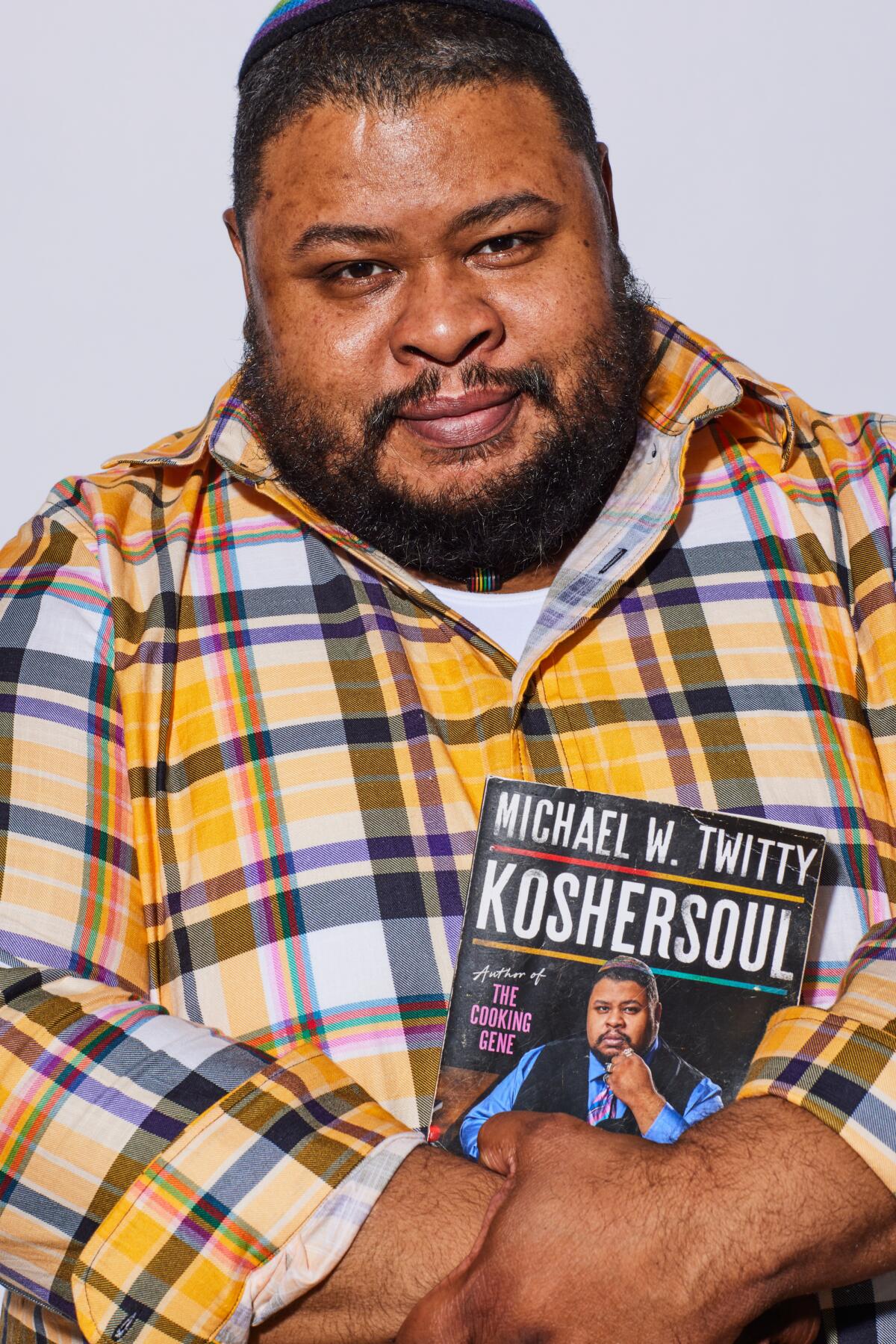 Chef Michael Twitty holds his book "Koshersoul"
