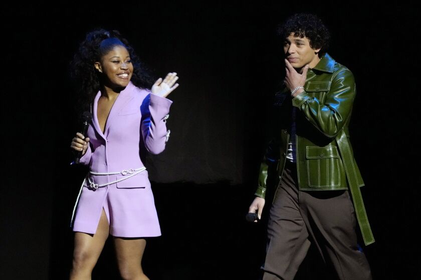 Dominique Fishback, left, and Anthony Ramos, cast members in the upcoming film "Transformers: Rise of the Beasts," are introduced onstage during the Paramount Pictures presentation at CinemaCon 2023, the official convention of the National Association of Theatre Owners (NATO) at Caesars Palace, Thursday, April 27, 2023, in Las Vegas. (AP Photo/Chris Pizzello)