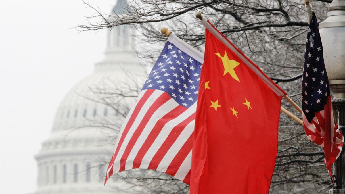 U.S. and Chinese flags fly near the Capitol in Washington in 2011.