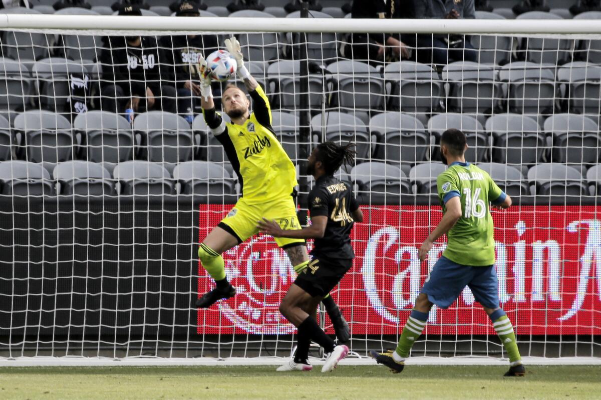 Seattle Sounders goalkeeper Stefan Frei makes a save in front of LAFC forward Raheem Edwards.