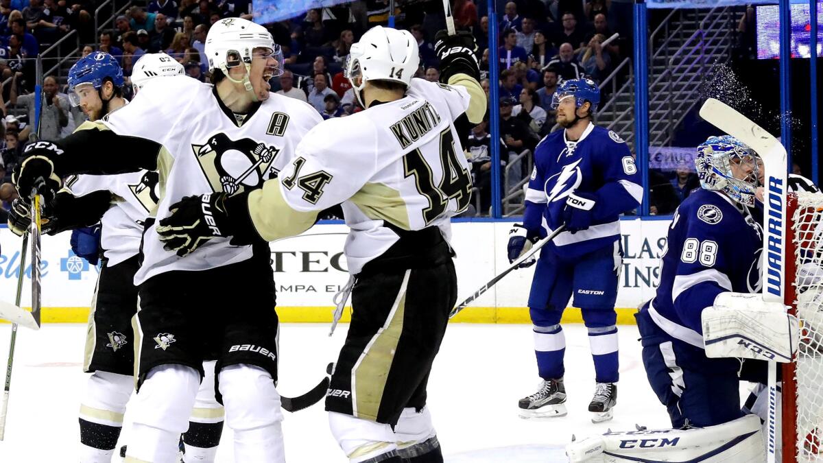 Penguins left wing Chris Kunitz (14) celebrate with center Evgeni Malkin after scoring a goal against the Lightning in the third period of Game 3 on Wednesday night.
