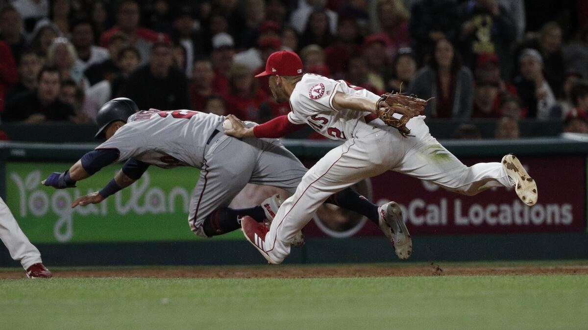 Angels shortstop Andrelton Simmons (2) tags out Minnesota Twins left fielder Eddie Rosario (20) as he was attempting to steal third base in the 9th inning.