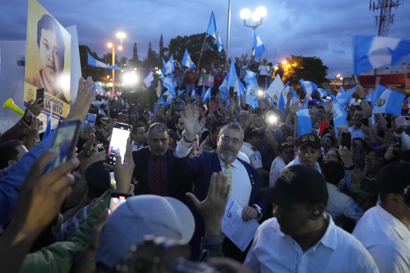 Guatemala's President-elect Bernardo Arévalo greets the crowd as he arrives at a march by Indigenous people to demand the resignation of Guatemala's Attorney General Consuelo Porras, outside the Supreme Court building in Guatemala City, Monday, Sept. 18, 2023. Arévalo has called people to protest efforts to derail his presidency before he can take office and for the attorney general's resignation. (AP Photo/Moises Castillo)
