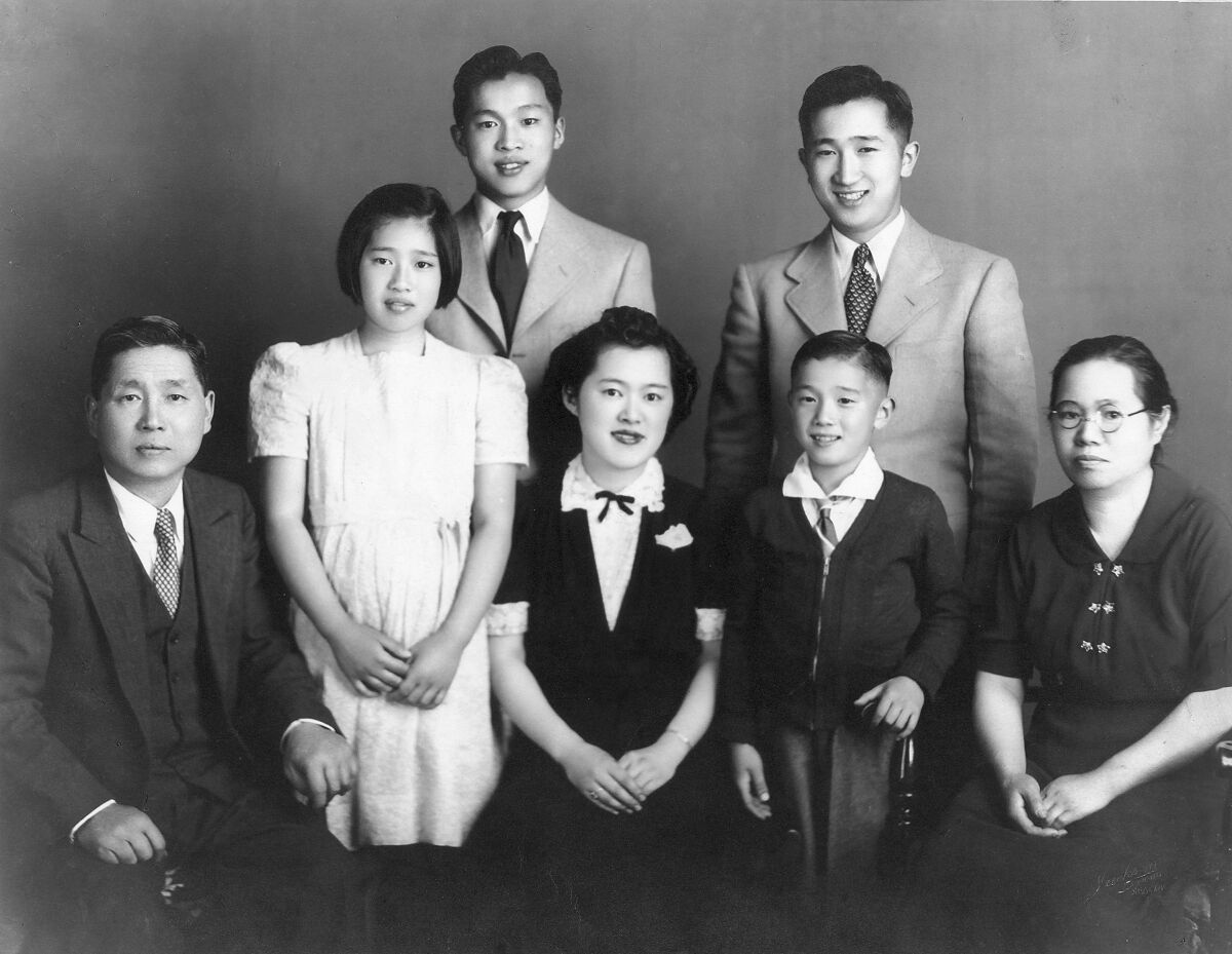 A black-and-white portrait of seven people 