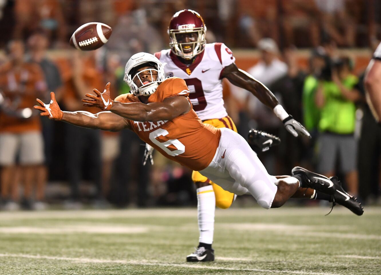 Texas receiver Devin Duvernay dives but can't make the catch as USC cornerback Greg Johnson defends in the second quarter at Royal-Texas Memorial Stadium.