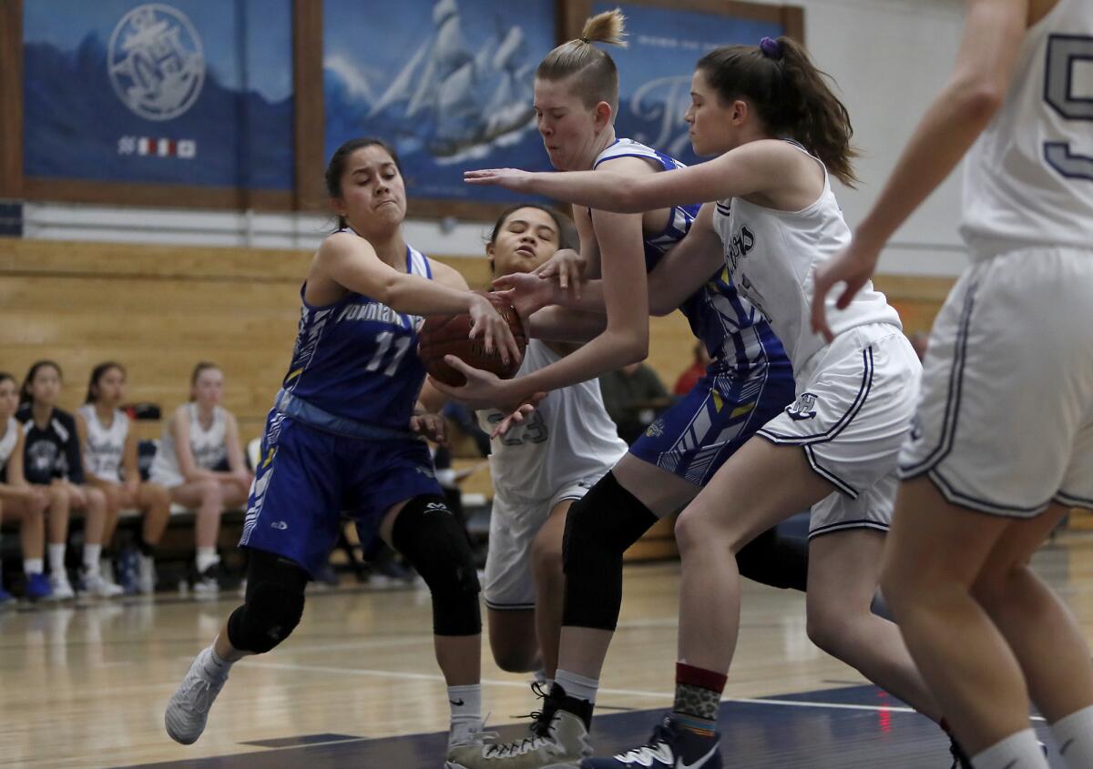 Fountain Valley’s Audrey Tengan, left, and Zoe Ziegler, second from right, battle for the ball against Newport Harbor’s Cydney Jover, second from left, and Chloe Swanson, right, during the first half of a Wave League game on Jan 18.