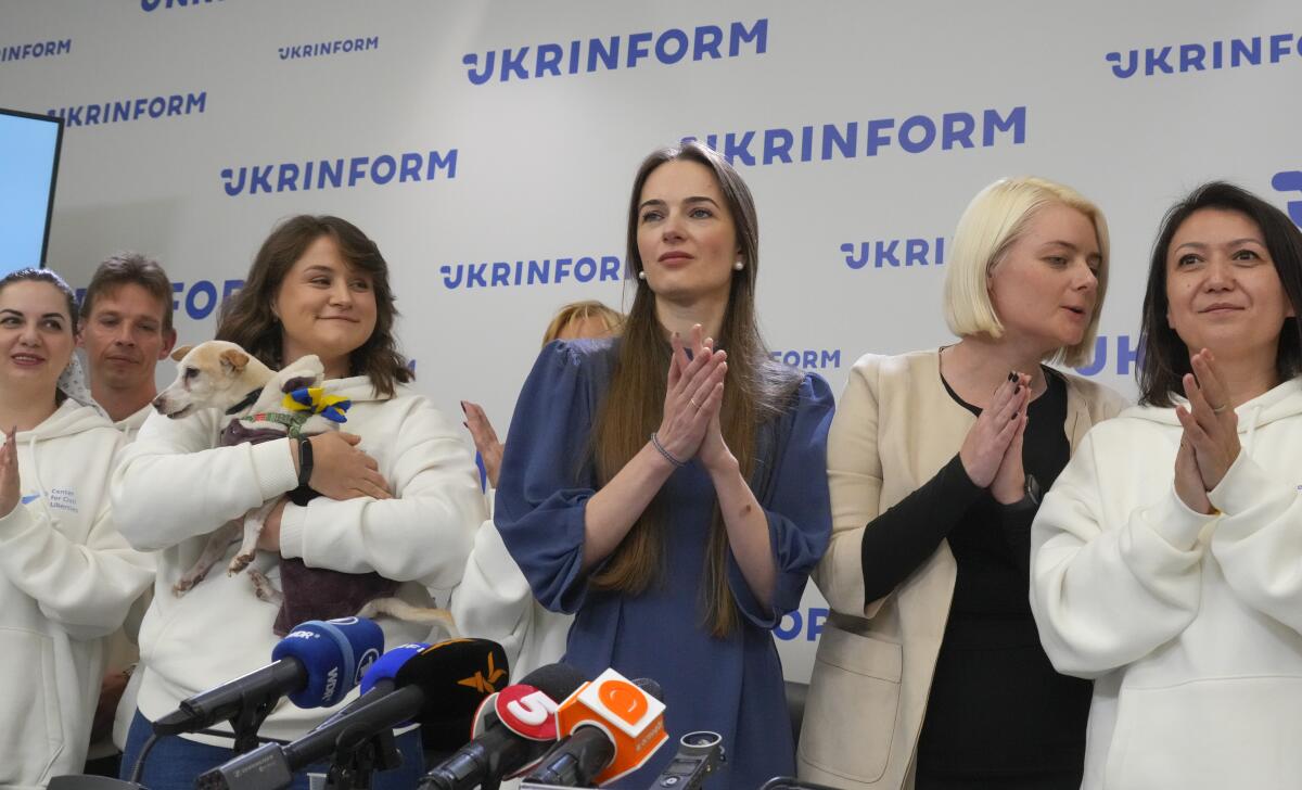 Center for Civil Liberties head of the board Oleksandra Matviychuk, center, executive director Oleksandra Romantsova, center left, and managers react after press conference in Kyiv, Ukraine, Saturday, Oct. 8, 2022. On Friday, Oct. 7, 2022 the Nobel Peace Prize was awarded to jailed Belarus rights activist Ales Bialiatski, the Russian group Memorial and the Ukrainian organization Center for Civil Liberties. (AP Photo/Efrem Lukatsky)