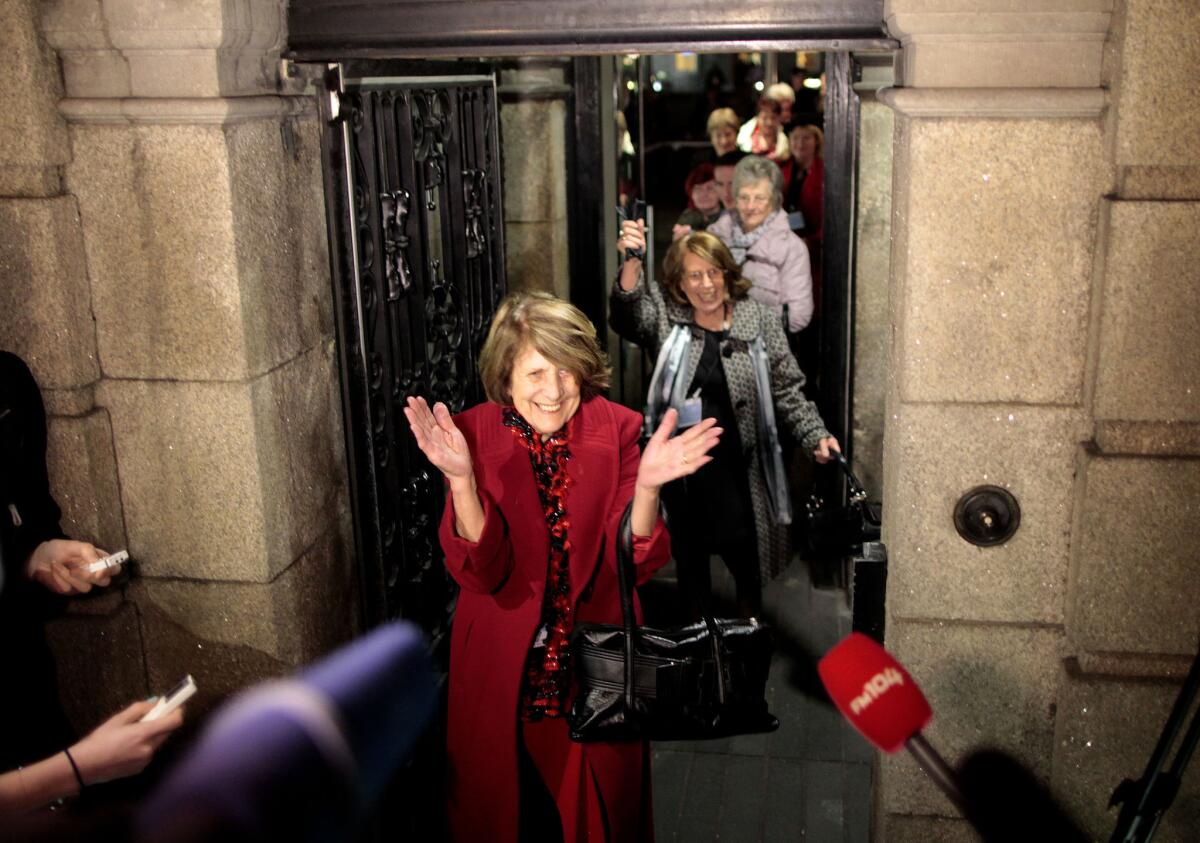 Kathleen Janette, who worked at the Catholic-run workhouses known as the Magdalen laundries, reacts along with other women after leaving the Irish Parliament building in Dublin on Tuesday.