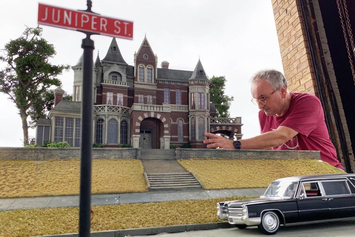 A man works on a miniature house for "The French Dispatch."