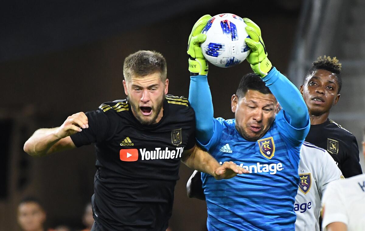LAFC's Walker Zimmerman tries to head the ball into the net but Real Salt Lake goalie Nick Rimando makes a save in the first half during a playoff game at Banc of California Stadium on Nov. 1, 2018.