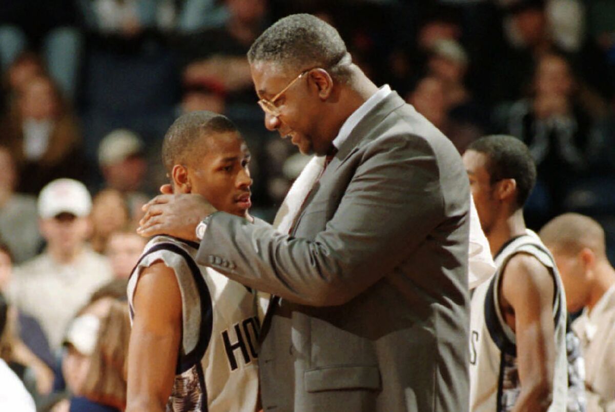 FILE - In this Jan. 24, 1996, file photo, Georgetown head coach John Thompson talks to Allen Iverson during an NCAA college basketball game against St. John's, in Landover, Md. Thompson, the imposing Hall of Famer who turned Georgetown into a basketball powerhouse and became the first Black coach to lead a team to the NCAA men’s title, has died at age 78, his family announced through the university, Monday, Aug. 31, 2020. (Porter Binks/USA Today via AP, File)