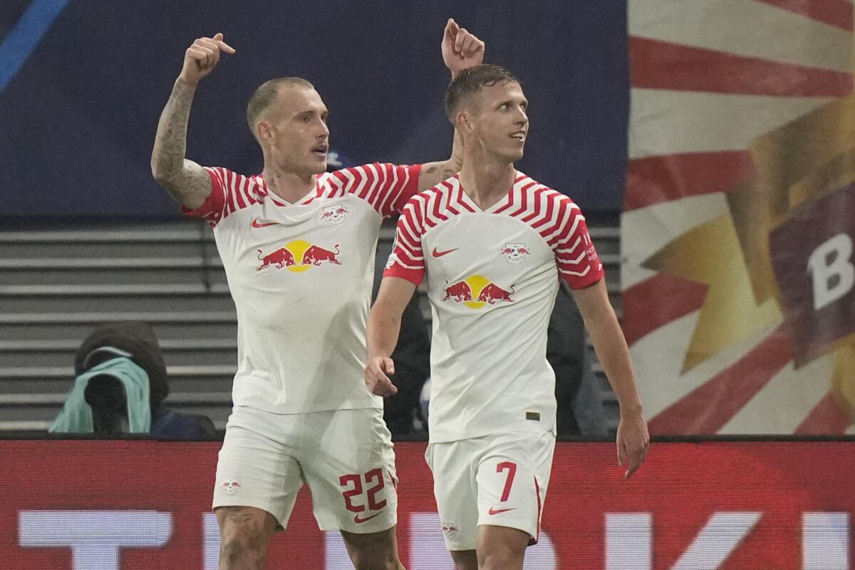 Leipzig's Dani Olmo, right, celebrates after scoring his side's third goal during the group G Champions League soccer match between RB Leipzig and Red Star Belgrade at the Red Bull arena stadium in Leipzig, Germany, Wednesday, Oct. 25, 2023. (AP Photo/Matthias Schrader)