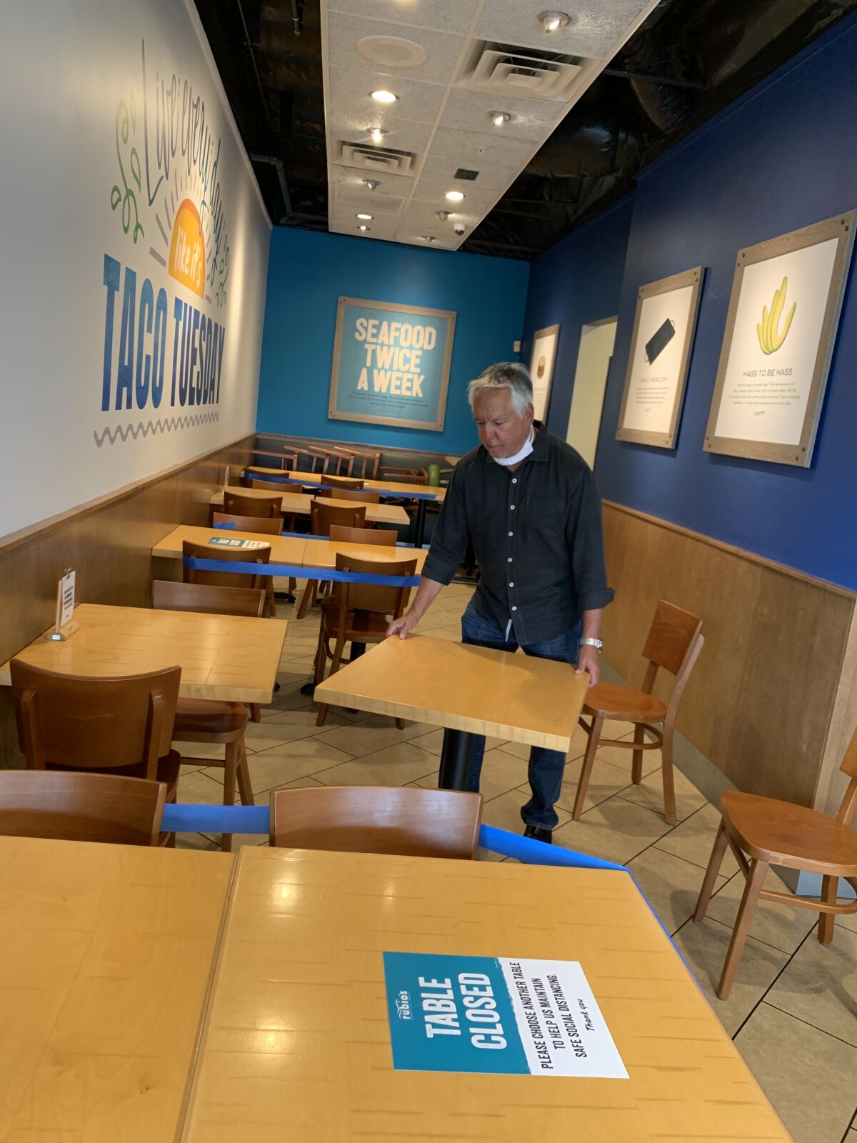 Rubio’s co-founder Ralph Rubio moves tables as Rubio’s restaurants implement strict social distancing procedures in preparation for re-opening their dining rooms on May 27.