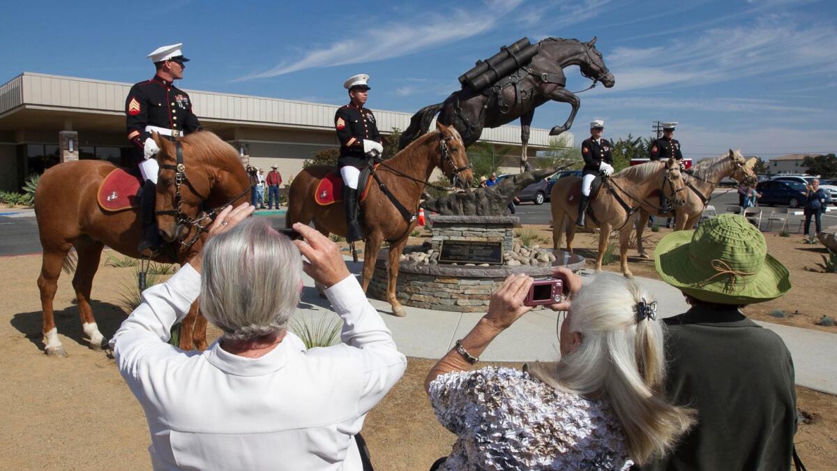 Reckless, a hero horse for the Marines, is honored with a statue at Camp Pendleton. The mounted color guard is from the Marine base in Barstow.