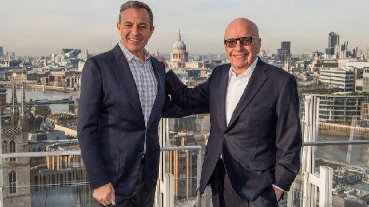 Disney CEO Bob Iger, left, and Fox Executive Chairman Rupert Murdoch celebrate Disney's agreement to buy certain Fox assets in London in December 2017.