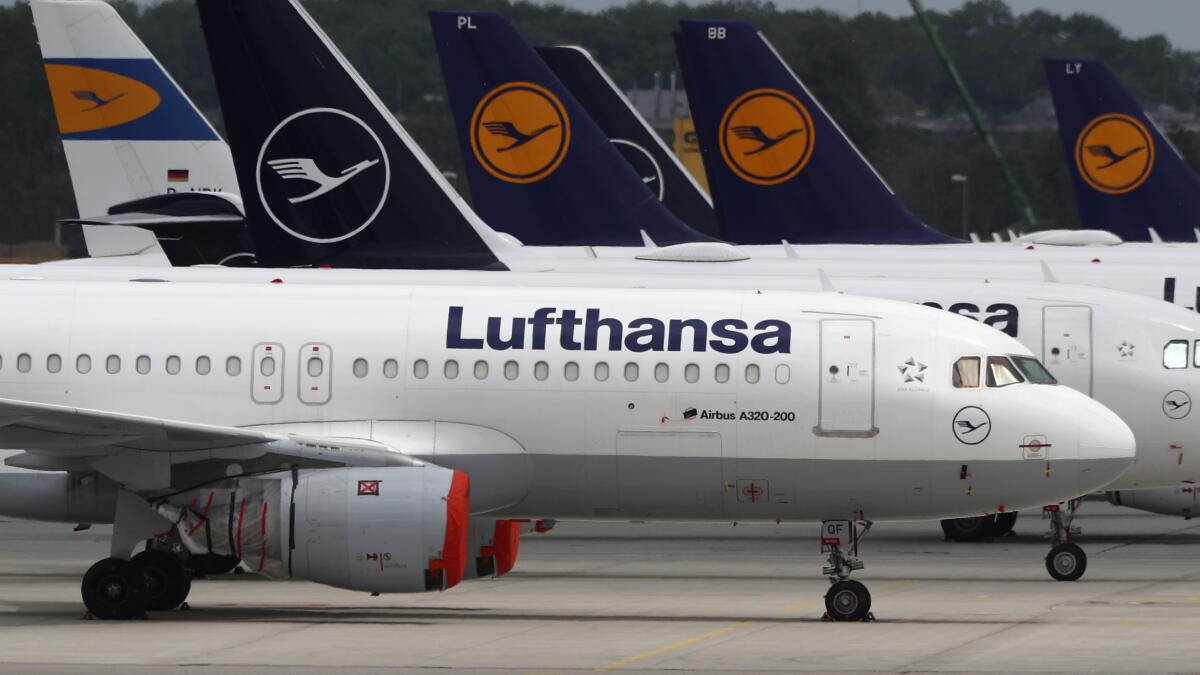 FILE -- Aircrafts of the German airline Lufthansa are parked at the airport in Munich, Germany, Tuesday, May 26, 2020. A union representing pilots at German carrier Lufthansa says they will stage a walk-out Friday after demands for a pay increase were rejected by management. (AP Photo/Matthias Schrader, file)