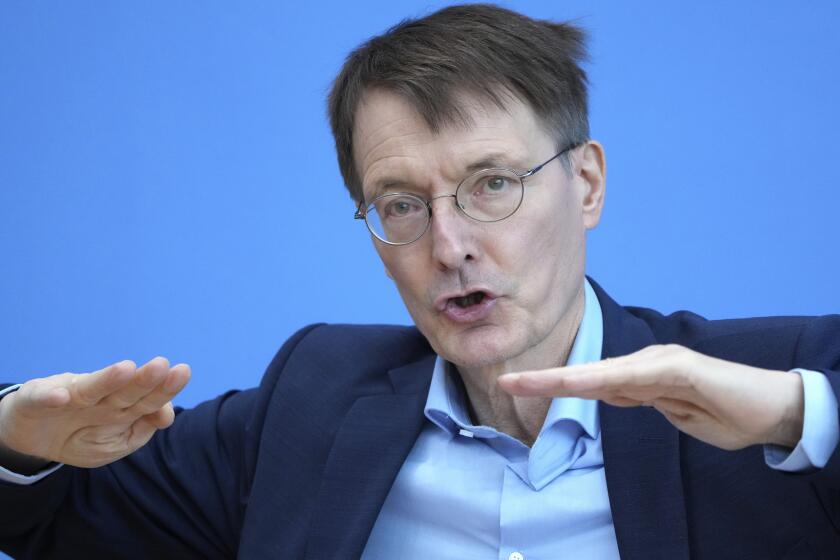 FILE - German Health Minister Karl Lauterbach gestures during a press conference on the current coronavirus pandemic in Berlin, Germany, Dec. 22, 2021. Germany’s health minister is urging his compatriots to be cautious during New Year celebrations, warning that the coronavirus infection rate is likely two to three times higher than current statistics show. (AP Photo/Michael Sohn, file)