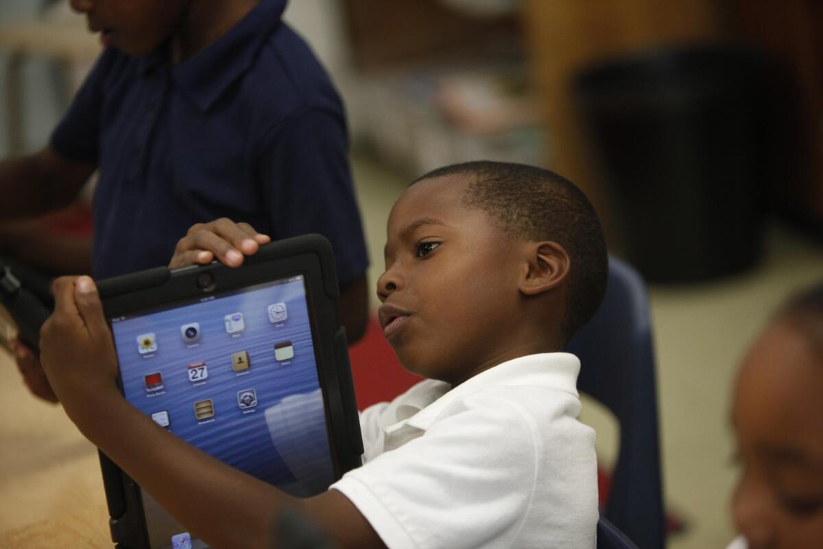 Avery Sheppard explores the possibilities with his new LAUSD-provided iPad. Students are increasingly learning how to use technology before turning the pages of a book.