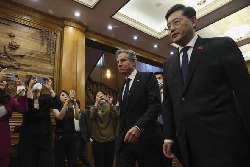 U.S. Secretary of State Antony Blinken, center, walks with Chinese Foreign Minister Qin Gang, right, at the Diaoyutai State Guesthouse in Beijing, China, Sunday, June 18, 2023. (Leah Millis/Pool Photo via AP)