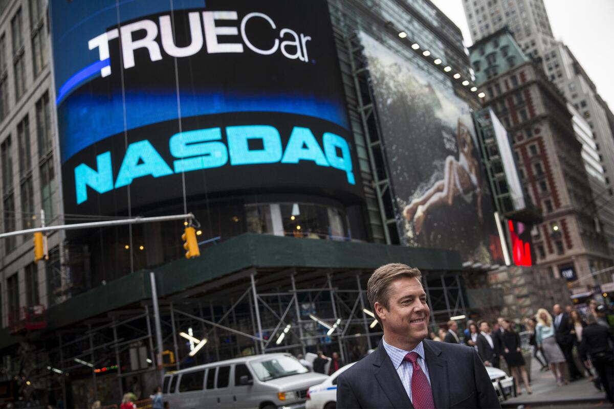 Scott Painter, CEO of TrueCar, stands outside the Nasdaq Exchange in Times Square in New York in this 2014 file photo. The company's shares plunged after it said it would miss its quarterly financial targets.